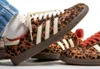 A close-up shot of a person wearing leopard-print Adidas Samba sneakers. Podgląd zdjęcia produktu