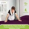 A hotel maid making a bed with aubergine colored sheets. Produktbild-Vorschau