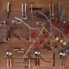 A collection of cutlery and decorative branches arranged on a wooden surface. Anteprima dell’immagine prodotto