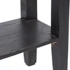 A close-up view of the corner of a black wooden table, showing the leg and shelf. Náhľad obrázku produktu