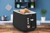 A black toaster with two slices of toast in it, placed on a wooden table in a kitchen setting. Voir les images du produit