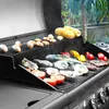 A variety of food items are being grilled on a gas grill outdoors. Produktbild-Vorschau