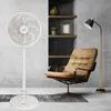 A modern living room setup with a standing fan, a chair, a floor lamp, and shelves. Podgląd zdjęcia produktu