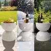 A triptych showing a white terrazzo side table in different weather conditions: sunny spring, snowy winter, and rainy summer. Podgląd zdjęcia produktu