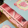 Close-up of a child's play vanity table with drawers open, showing accessories like a comb and mirror. Podgląd zdjęcia produktu