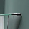 Close-up of a shower enclosure corner, showing the glass edge and metal frame against a wall. Produktbild-Vorschau