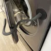 A close-up view of a washing machine door and a flexible, magnetic door holder attached to it. Produktbild-Vorschau