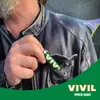 A person's hand is putting a VIVIL mint stick into the pocket of a leather jacket. Produktbild-Vorschau