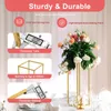 A gold rectangular flower stand with a floral arrangement on top, set on a table with other decorative elements. Produktbild-Vorschau