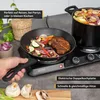 A double electric hot plate is shown cooking food in a pan and a pot. Produktbild-Vorschau
