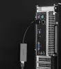 The back of a computer tower with an adapter plugged into one of the ports. Voir les images du produit