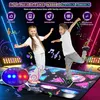 Two children are dancing on a light-up dance mat in a dark room with neon lights. Produktbild-Vorschau