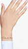 A close-up shot of a woman's hand wearing a gold bracelet with clear stones. Produktbild-Vorschau