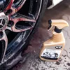A close-up of a car wheel being cleaned with a spray bottle. Náhled obrázku produktu