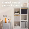 A white shelving unit filled with storage baskets and binders, with a felt storage bin in the foreground holding rolled paper. Produktbild-Vorschau