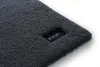 A close-up of a dark gray bath mat with a black label featuring the brand name 'JOOP!' Podgląd zdjęcia produktu