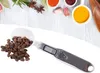 A digital spoon scale filled with coffee beans, with spices in the background. Náhľad obrázku produktu