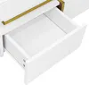 A close-up view of an open white drawer with a gold handle on a white surface. Produktbild-Vorschau