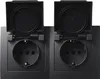 A close-up studio shot of two black electrical outlets with their protective covers open. Produktbild-Vorschau