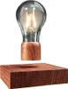 A levitating light bulb with a wooden base. Produktbild-Vorschau