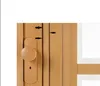 A close-up view of a wooden folding or sliding door with a handle and lock mechanism. Arrows point to specific details on the door. Podgląd zdjęcia produktu