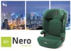 A green child car seat is displayed in front of a city skyline at night. Podgląd zdjęcia produktu