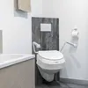 A bathroom setting with a toilet and bathtub. Produktbild-Vorschau