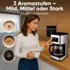 A woman is holding a coffee cup and interacting with a coffee machine in a kitchen setting. Anteprima dell’immagine prodotto