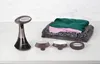 A fabric steamer and accessories are displayed next to folded clothes on a white surface with a marble-like background. Produktbild-Vorschau