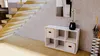 Interior view of a modern hallway with a wooden staircase, a white shelving unit, and an umbrella stand. Náhled obrázku produktu