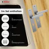 A set of door handles and their included accessories are displayed against a wooden background, with a black overlay detailing the contents of the set. Produktbild-Vorschau