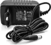 A black AC adapter with a coiled cable and a DC connector is shown against a white background. Produktbild-Vorschau