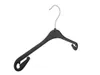 A black plastic clothes hanger with a metal hook, shown against a white background. Produktbild-Vorschau