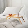 A breakfast tray with croissants and a coffee drink is set up on a bed with white linens and pillows. Podgląd zdjęcia produktu