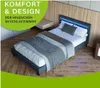 A modern bedroom with a bed featuring blue LED lighting. Náhled obrázku produktu