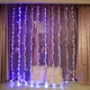 A decorated window with string lights and feathers, with two pillows in the foreground. Produktbild-Vorschau