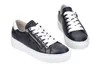 A pair of black leather sneakers with white laces and white soles, shown against a white background. Produktbild-Vorschau