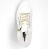 A top-down view of a white high-top sneaker with cream-colored fur trim and gold laces. Produktbild-Vorschau