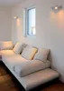 A modern living room with a sectional sofa and a window. Podgląd zdjęcia produktu