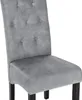 A close-up view of a gray upholstered dining chair with tufted backrest and black wooden legs. Produktbild-Vorschau