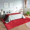 A bedroom scene with a bed, rug, and furniture. Produktbild-Vorschau