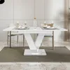 A white dining table with place settings and a bottle of water, set in a modern dining room. Produktbild-Vorschau