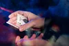 A close-up shot of hands performing a card trick with a Bicycle playing card. Produktbild-Vorschau