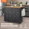 A black kitchen island with a wooden countertop is shown in a kitchen setting. It has drawers, cabinets, and towel racks. There are also some decorative items on the countertop. Produktbild-Vorschau