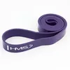A purple exercise band is shown coiled and partially uncoiled against a white background. Produktbild-Vorschau
