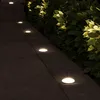 Outdoor pathway illuminated by ground lights next to a hedge. Produktbild-Vorschau