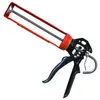 A red and black caulking gun is shown against a white background. Podgląd zdjęcia produktu