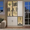A modern white vitrine with LED lighting, displaying books and decorative items, placed in a living room setting next to a window. Anteprima dell’immagine prodotto