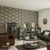 A living room scene with a patterned wallpaper, fireplace, leather armchair, glass display cabinets, coffee table, and sofa. Podgląd zdjęcia produktu