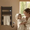 A mother and child in bathrobes in a bathroom, with a towel warmer in the background. Anteprima dell’immagine prodotto